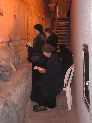 Women pray opposite the longest stone