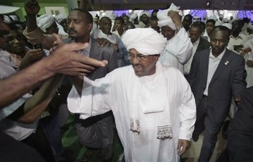 Sudan's president Omar al-Bashir, center, is congratulated by his supporters at the ruling party headquarters in Khartoum, Sudan, Monday, April 26, 2010. by Pan-African News Wire File Photos
