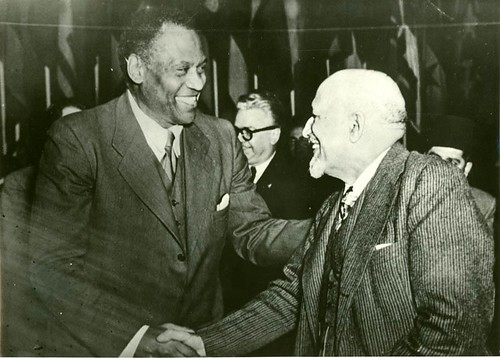 Singer, actor and social activist Paul Robeson greets the scholar/activist Dr. W.E.B. DuBois at the 1949 Paris Peace Conference which both men addressed. They would later draw fire from the imperialists for their work for peace. by Pan-African News Wire File Photos