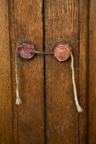 Two wax seals on a wooden door