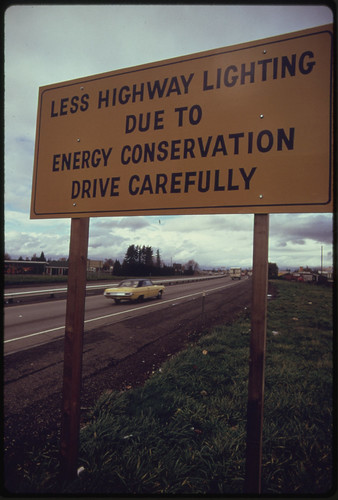 Posted Highway Sign Along Interstate #5 Explains Lack of Highway Lighting Is Due to Energy Conservation 11/1973