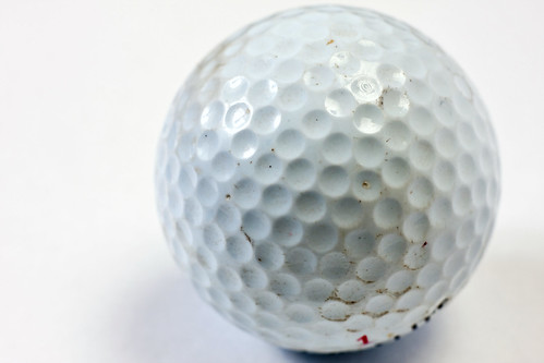 Macro of scratched and dirty white golf ball