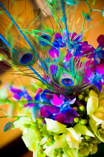 Spice up your wedding centerpieces by adding a few peacock feathers