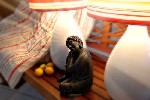 The Good Year: light of a black Buddha, reflecting on the past year, Indonesian teak bench, lemons, two lamps, bedspread, San Mateo, California, USA by Wonderlane