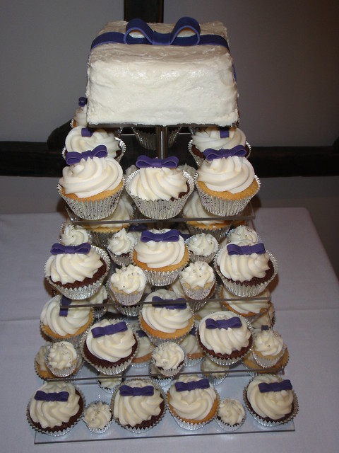 Dark purple bow wedding cupcakes A mix of white on white mud and double 