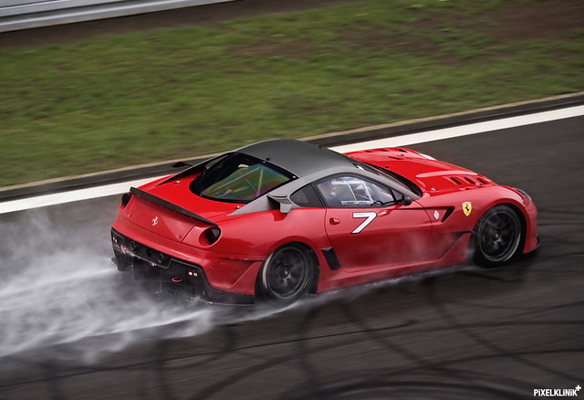 Fearless Ferrari 599XX driver push it to the limit in heavy rain during