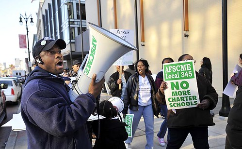 Union official stands in protest against the corporate-engineered plans to drive more people from the city at the aegis of the banks and multi-national firms who have wrecked Detroit over the last five decades. by Pan-African News Wire File Photos