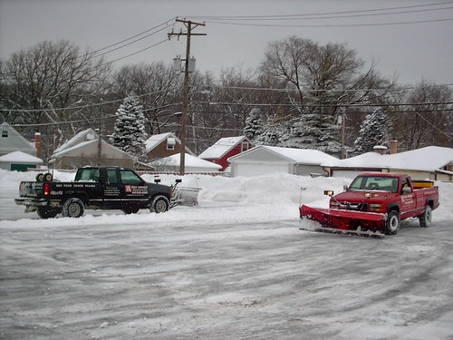 Snowplow trucks double teaming a parking lot after a heavy lake effect snowstorm. River Grove Illinois. Febuary 2008. by Eddie from Chicago