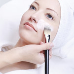 beautician applying cosmetic mask