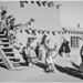 Indians in headdress, male and female, descending stairs, "Dance, San Ildefonso Pueblo, New Mexico."