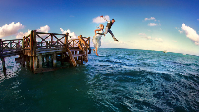 Wedding day at Dominicana - 16 p.m., sunset - bride and groom jump into the ocean