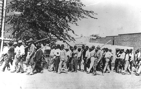 African-Americans being marched through Tulsa, Oklahoma when white racists killed over 300 people and destroyed numerous homes, churches and businesses in a rampage supported by the authorities. by Pan-African News Wire File Photos