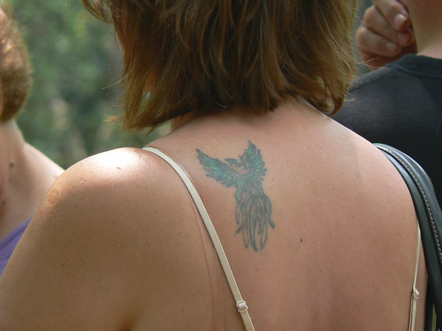 Woman with Phoenix Tattoo on her Back Close up