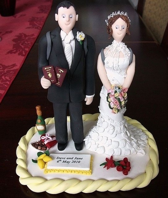 Travel themed wedding cake toppers complete with passports and map of work 