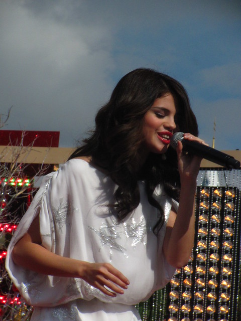 Selena Gomez performs in front of Sleeping Beauty Castle