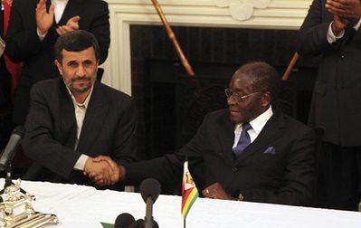 Iranian President Mahmoud Ahmadinejad, left, and Zimbabwean President Robert Mugabe shake hands, after addressing a press conference after signing a memorandum of understanding between Iran and Zimbabwe at State House in Harare, Thursday, April 22, 2010. by Pan-African News Wire File Photos