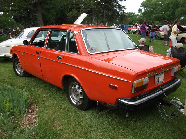 Great 1974 Volvo 144 in orange towing a trailer