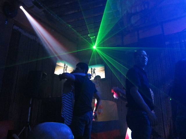 Green lasers shoot out from above the DJ booth.