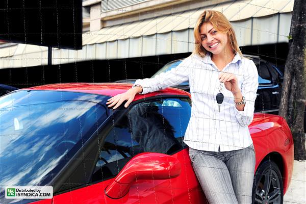 happy woman showing key of new sports car