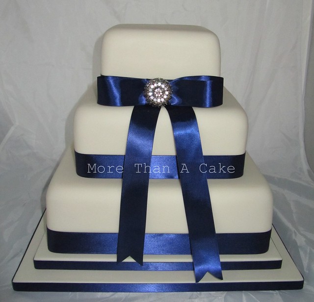 Wedding dummy cake Ivory fondant and navy ribbon with a sparkly brooch
