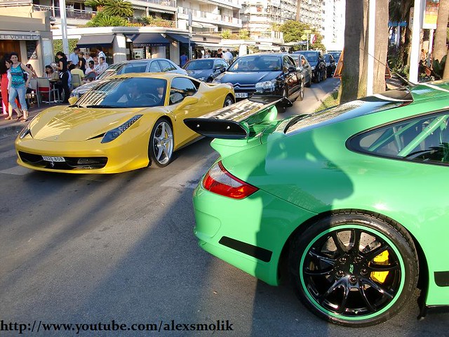Yellow Ferrari 458 italia next to a green Porsche GT3RS with black rims and