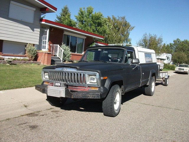 1971 Jeep J10 truck with a Chrysler Cordoba behind