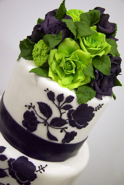 purplelimeroseweddingcake A 4 tier white fondant wedding cake with a 
