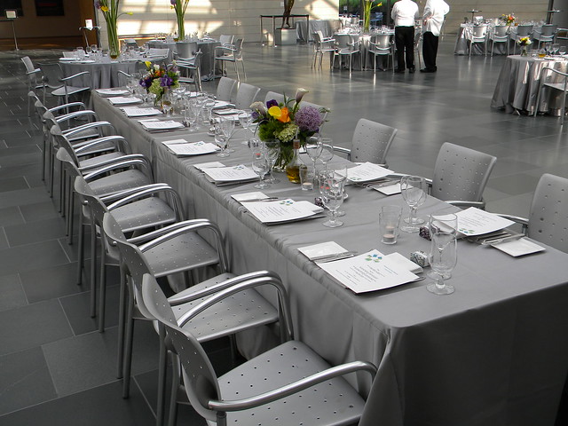 Silver tablecloths play off brushed aluminum chairs