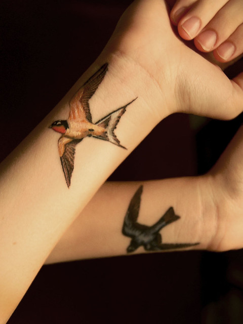 My first tattoos Tree swallow on my left wrist barn swallow on my right