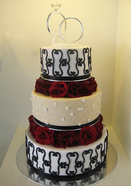 a wedding cake full of contrasts the black and white tiers add a dramatic