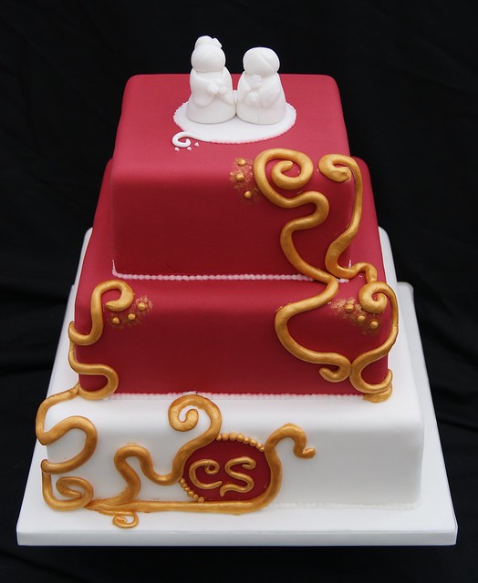 Large swirls climb the sides painted with edible gold luster to give a 