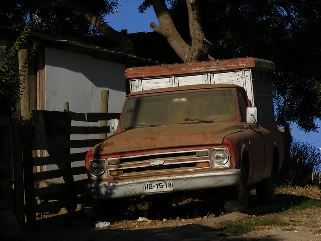 An Old Chevy C K truck model is probably waiting a maintenance in a lonely