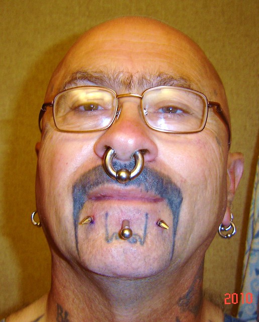 my snakebites and mustache tattoo just got my new snakebite peircings