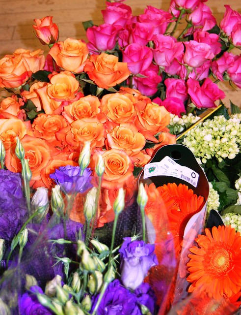 Purple lisianthus hot pink and tangerine roses orange gerbers and green 