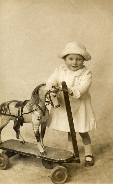 Child with a toy horse in 1912