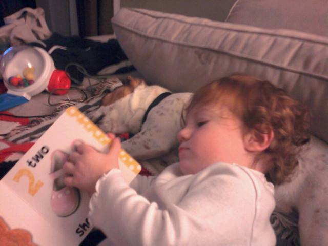 Reading bedtime stories to her puppy.