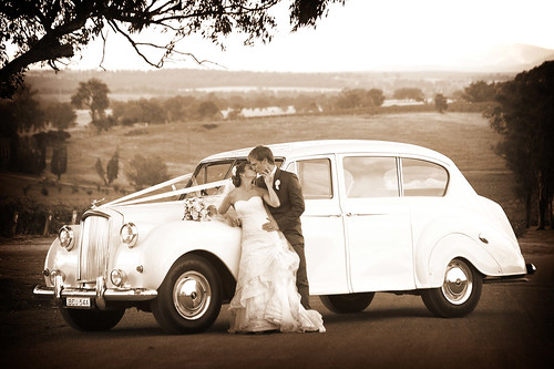Bride and groom with a Princess car.