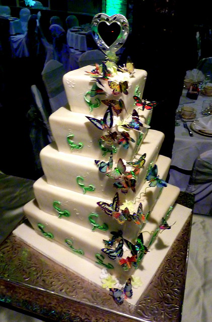 A whimsical wedding cake adorned with realistic butterflies