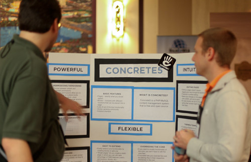 gesturing toward info on the Concrete5 poster
