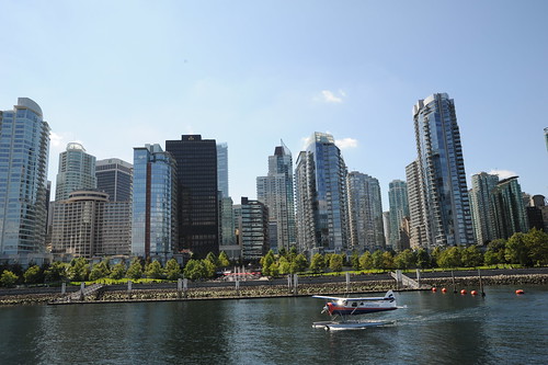 Float plane landing in Vancouver BC harbor, modern skyscrapers, cranes building, Life Release Project, Lotus Speech Canada by Wonderlane