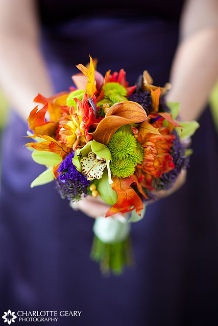 Bridesmaid with purple dress and orange bouquet From a wedding at Town