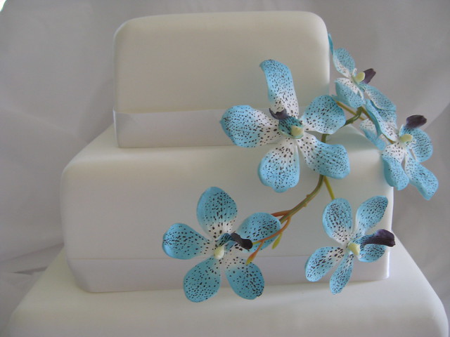 wedding cake with blue orchids