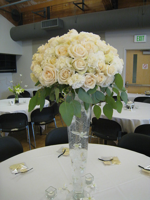Tall rose centerpiece 28 glass vase with a large dome of white carnations 