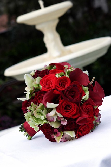 Red roses with green cymbidium orchids and antique hydrangea