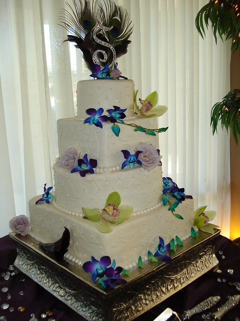 tye dyed orchids peacock feathers wedding cake