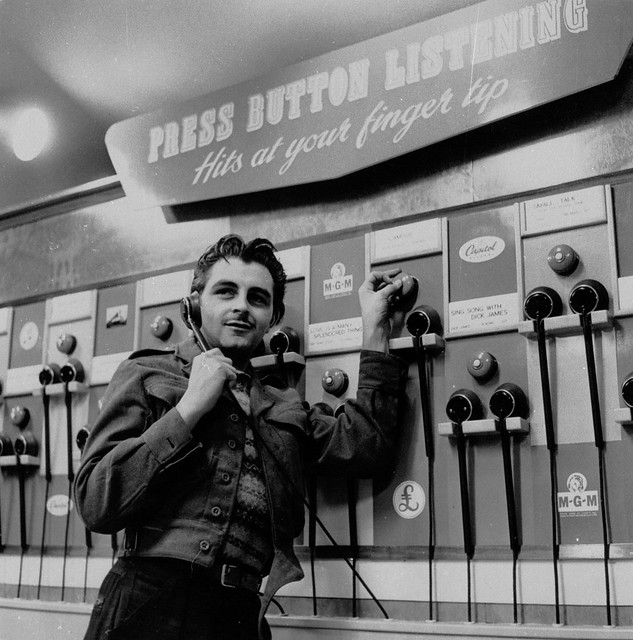 hmv 363 Oxford Street, London - Customer using listening post 1950s