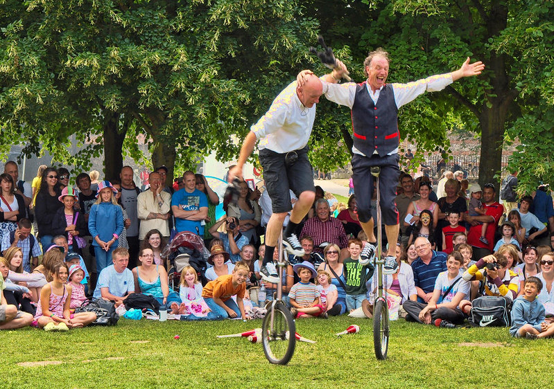 Unicycle jugglers entertain the crowd in the Cathedral Close. Credit Anguskirk, flickr