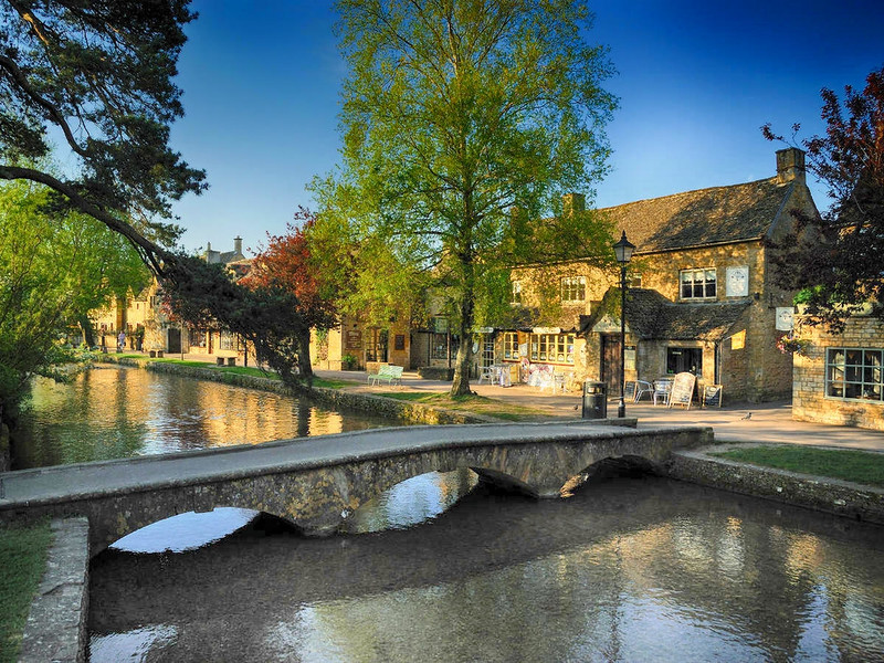 Footbridge over the River Windrush at the Cotswolds village of Bourton-on-the-Water. Credit Saffron Blaze
