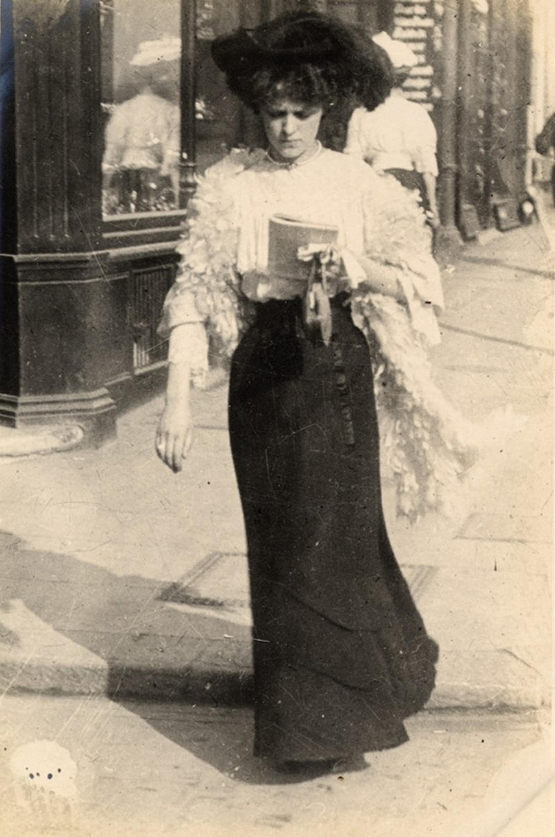 This woman is a shop salesperson, walking along Kensington Church Street, on September 8, 1906