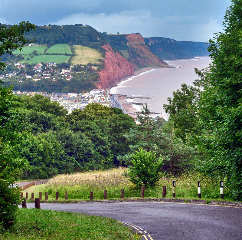 Peak Hill Road & Scenery. From the road looking back down towards Sidmouth and the Jurrasic Coast. Credit Lewis Clarke